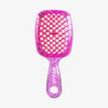 Die UNbrush Detangling Hair Brush Mini hat eine pinke, glitzernde Oberfläche mit einem wabenförmigen, belüfteten Paddel und einem passenden Griff.