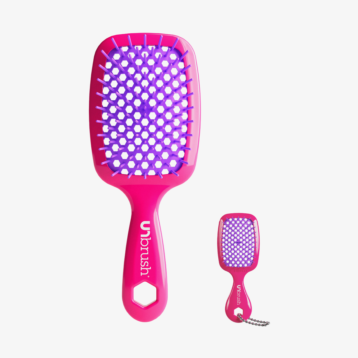 UNbrush und Super-Mini-Set Neon Pink mit einer neonpinken Haarbürste und einer passenden Mini-Bürste als Schlüsselanhänger mit lila Borsten.