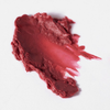 Ein cremiger, verschmierter Strich in der Farbe „BLONDESISTER 2 IN 1 IT’S UP TO YOU LIP OR CHEEK“ – rot auf weiß, mit ungleichmäßigen Rändern.