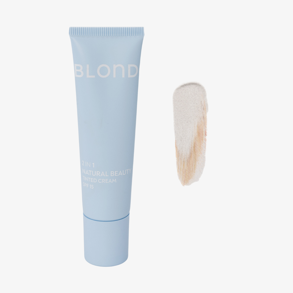 Eine hellblaue BLONDESISTER-Tube mit der Aufschrift „2 IN 1 NATURAL BEAUTY TINTED CREAM SPF15“ und einem beigen Farbmuster auf weißem Hintergrund.
