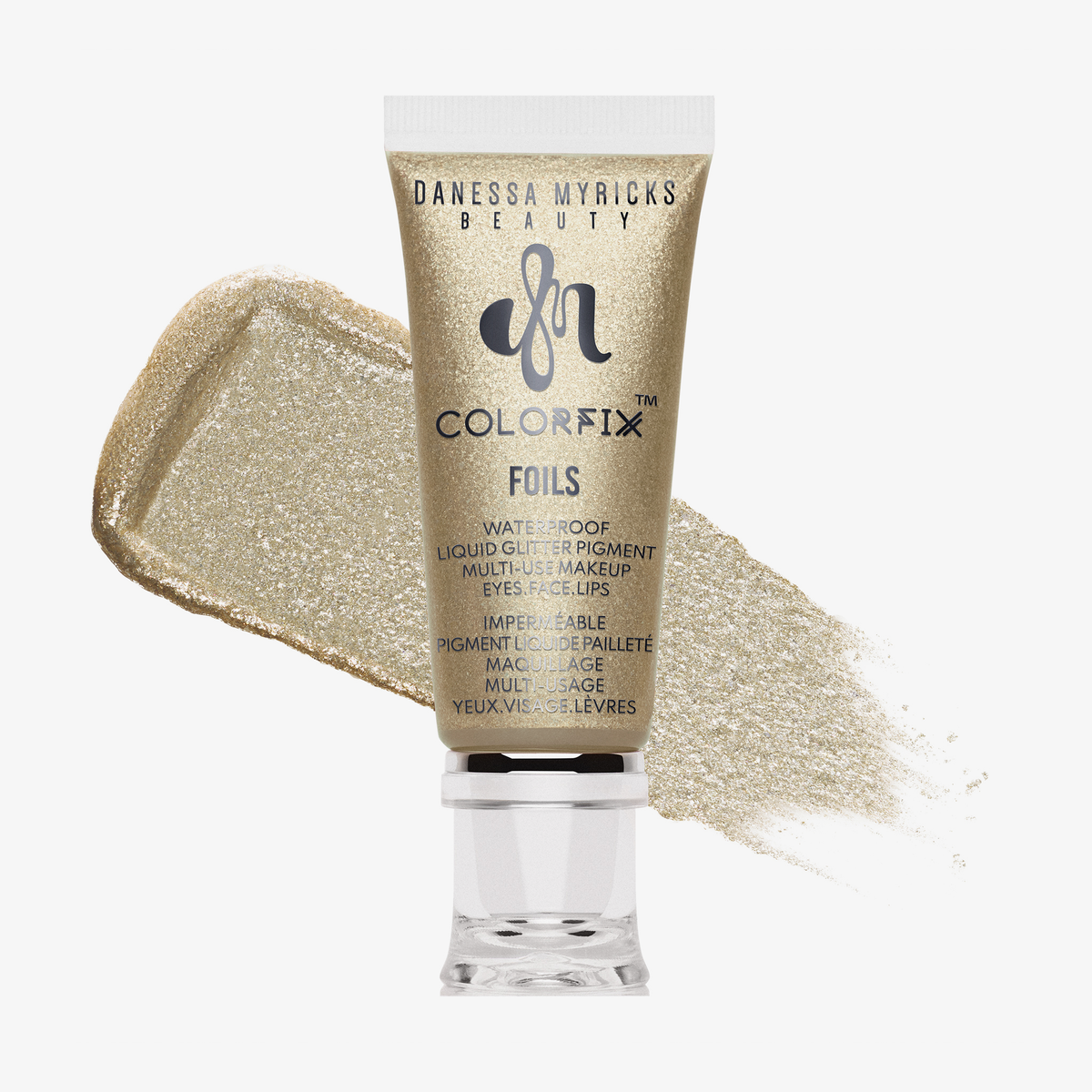 Eine goldene Tube von Danessa Myricks Beauty Colorfix Foils in Milky Way mit schimmerndem Goldpigment dahinter.