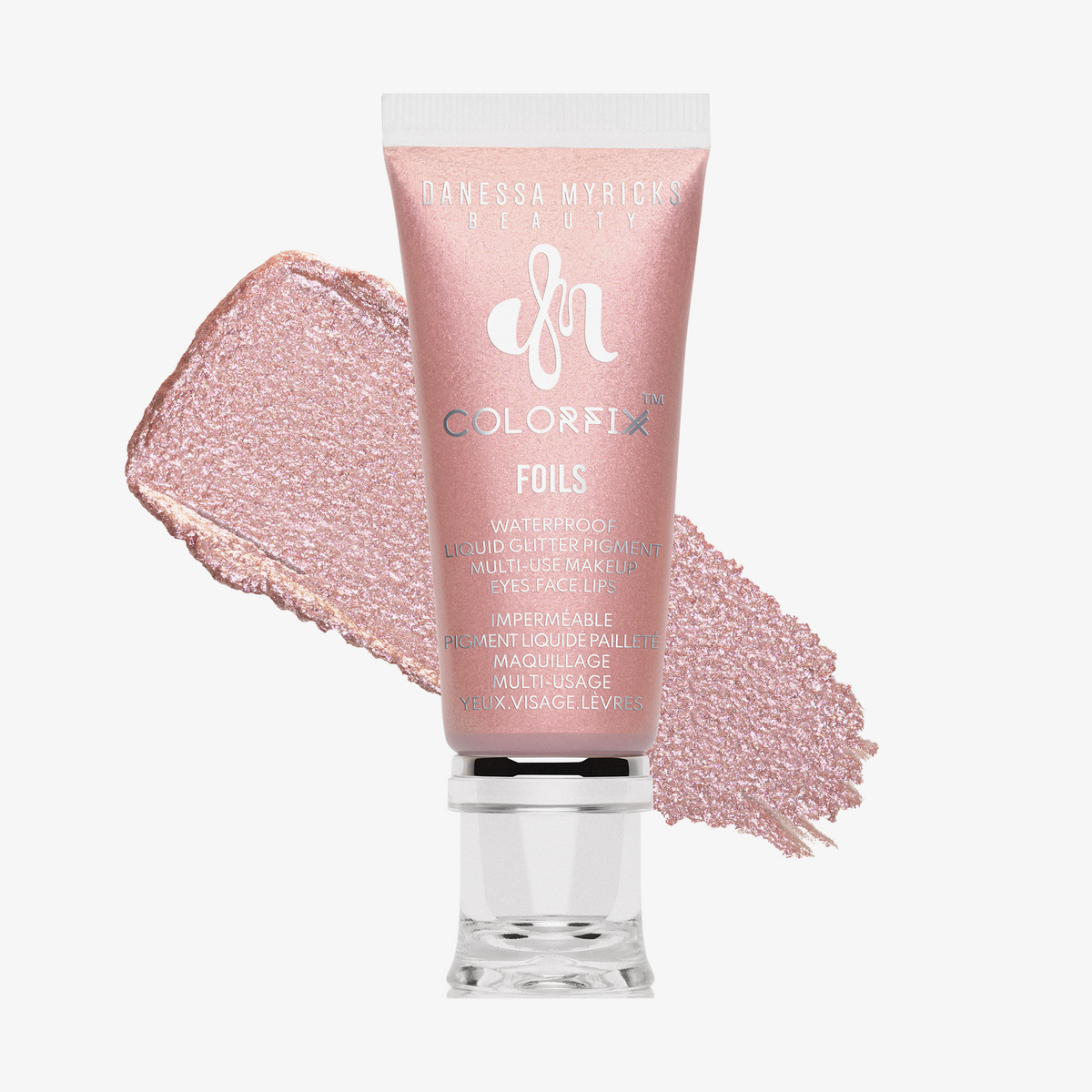 Eine Tube Danessa Myricks Beauty Colorfix Foils rosa Glitzer-Make-up mit einem Abstrich des Produkts dahinter.