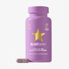Eine violette Flasche BLOATamin™ , vor der sich eine Kapsel mit violettem Pulver befindet.