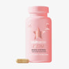 Eine rosa Flasche HAIRtamin MOM 1 Month neben einer einzelnen Kapsel auf weißem Hintergrund.
