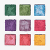 Neun kräftige Farbtöne aus der Palette 1993 von LH Cosmetics sind in einem Raster auf weißem Hintergrund angeordnet.