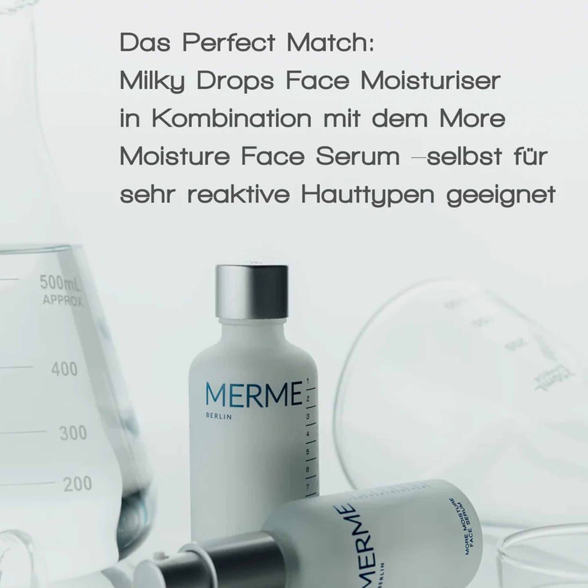 Zwei MERME Berlin Fläschchen mit silbernem Deckel vor Labor-Glasgefäßen. Text: „Das Perfect Match: Milky Drops + More Moisture serum – selbst für reaktive Haut geeignet“.