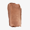 Ein Farbmuster des „Art Of Skin Glazing Stick“ von NABLA Cosmetics in schimmerndem Bronze, aufgetragen auf einem weißen Hintergrund.