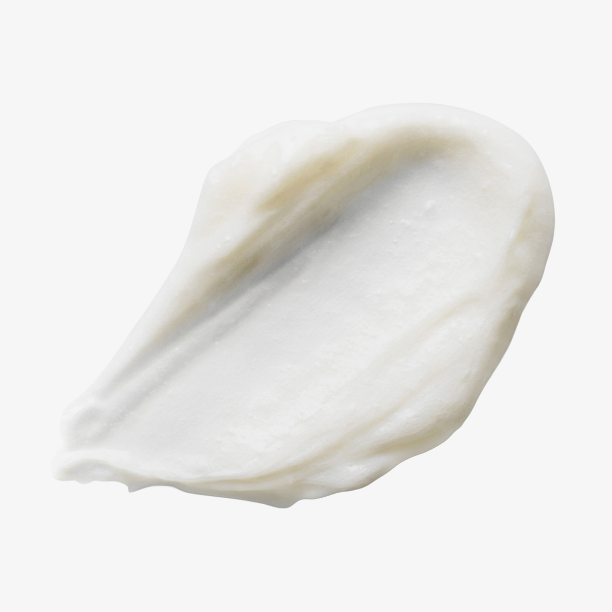 Ein Klecks der dickflüssigen, weißen „Philip Kingsley Density Stimulating Mask“ auf einem schlichten weißen Hintergrund.