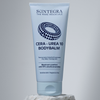 Eine Tube „Skintegra Cera-Urea 10 Bodybalm“ steht aufrecht auf einem Stein vor einem neutralen Hintergrund.