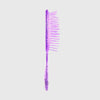 Die UNbrush Detangling Hair Brush Mini in lila Glitzer steht aufrecht vor einem schlichten hellgrauen Hintergrund.