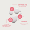 Bali Body Face Tan Milk Drops: weißes Serum mit rosafarbenen Symbolen/Text, die die Vorteile von Hyaluronsäure, Ceramiden und Vitamin C hervorheben.