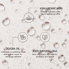 Bali Body Face Tan Mist: Hyaluronsäure, Jojobaöl und 100 % natürliches DHA für eine mit Feuchtigkeit versorgte, strahlende Haut vor einem strukturierten Hintergrund.