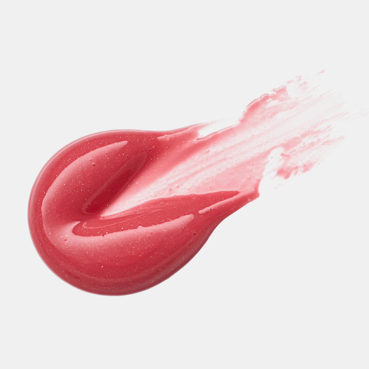 Ein rosafarbener, glänzender Tupfer des Diamond Glaze Gloss Stick von Catrice Cosmetics bringt einen weißen Hintergrund zum Strahlen.