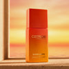 Catrice Cosmetics MIDNIGHT SUN Blush Drops-Fläschchen auf einem Sims mit einem warmen, sonnenuntergangsfarbenen Hintergrund.
