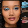 Frau trägt blaues Augen-Make-up, nudefarbene Grundierung und glänzende Lippen mit Danessa Myricks Beauty Colorfix Mattes für Augen, Gesicht und Lippen.