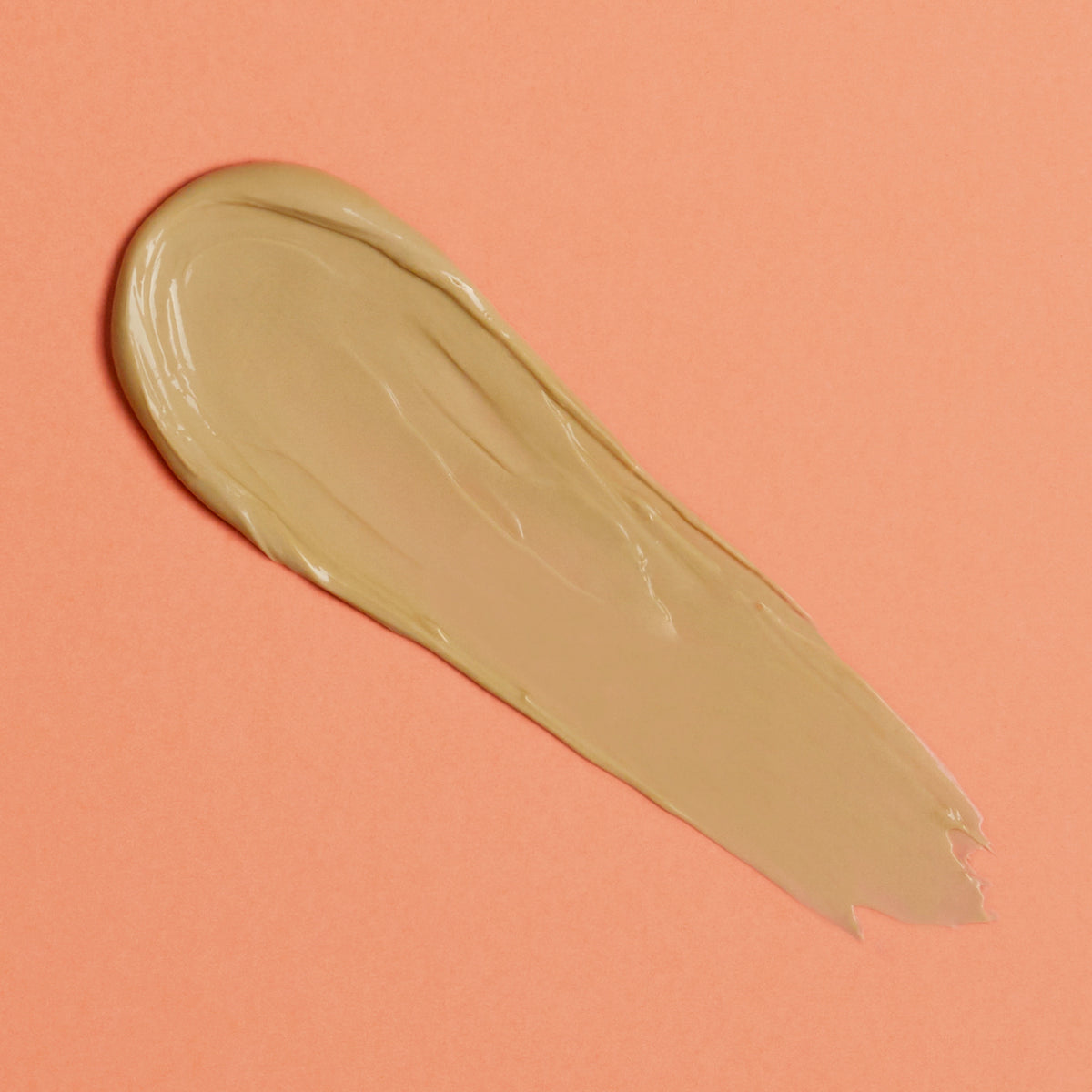 Braunbeiger Klecks der Hanskin Vitamin C Glow Mask auf orangem Hintergrund.