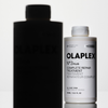 OLAPLEX N°3 PLUS Complete Repair Treatment Flasche mit Schattensilhouette auf weißem Hintergrund.