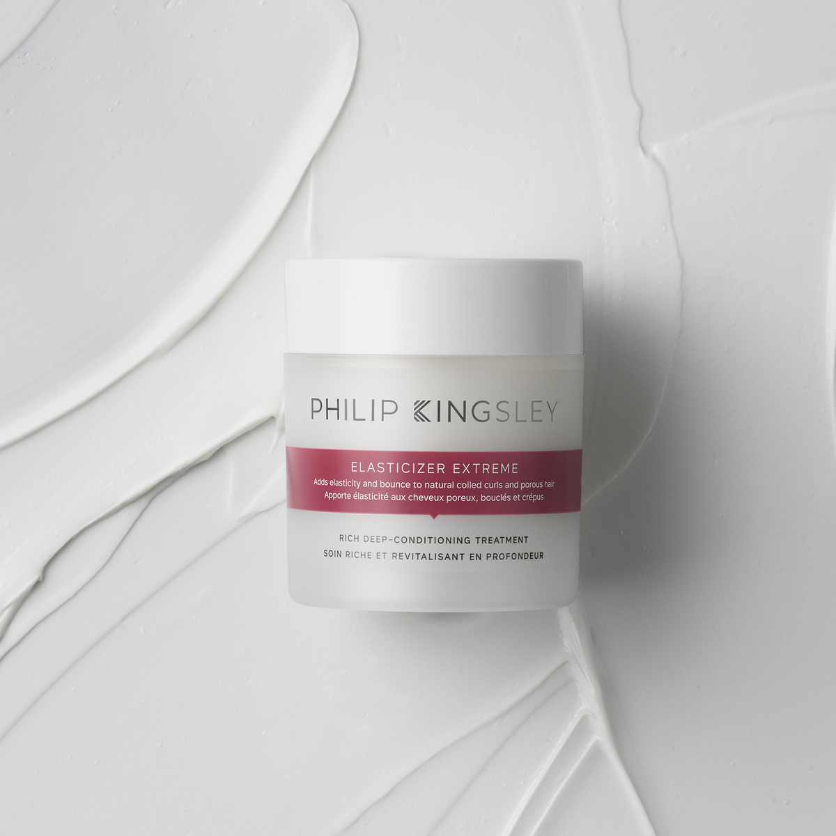 Philip Kingsley Elasticizer Extreme Intensivpflege-Tiegel auf einer weißen, strukturierten Oberfläche.