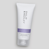 Eine weiße Tube „Philip Kingsley Pure Blonde/Silver Daily Brightening Conditioner“ vor einem hellgrauen Hintergrund.