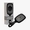 Die schwarze UNbrush Detangling-Haarbürste mit sechseckigem Muster wird neben der passenden Verpackungsbox präsentiert.