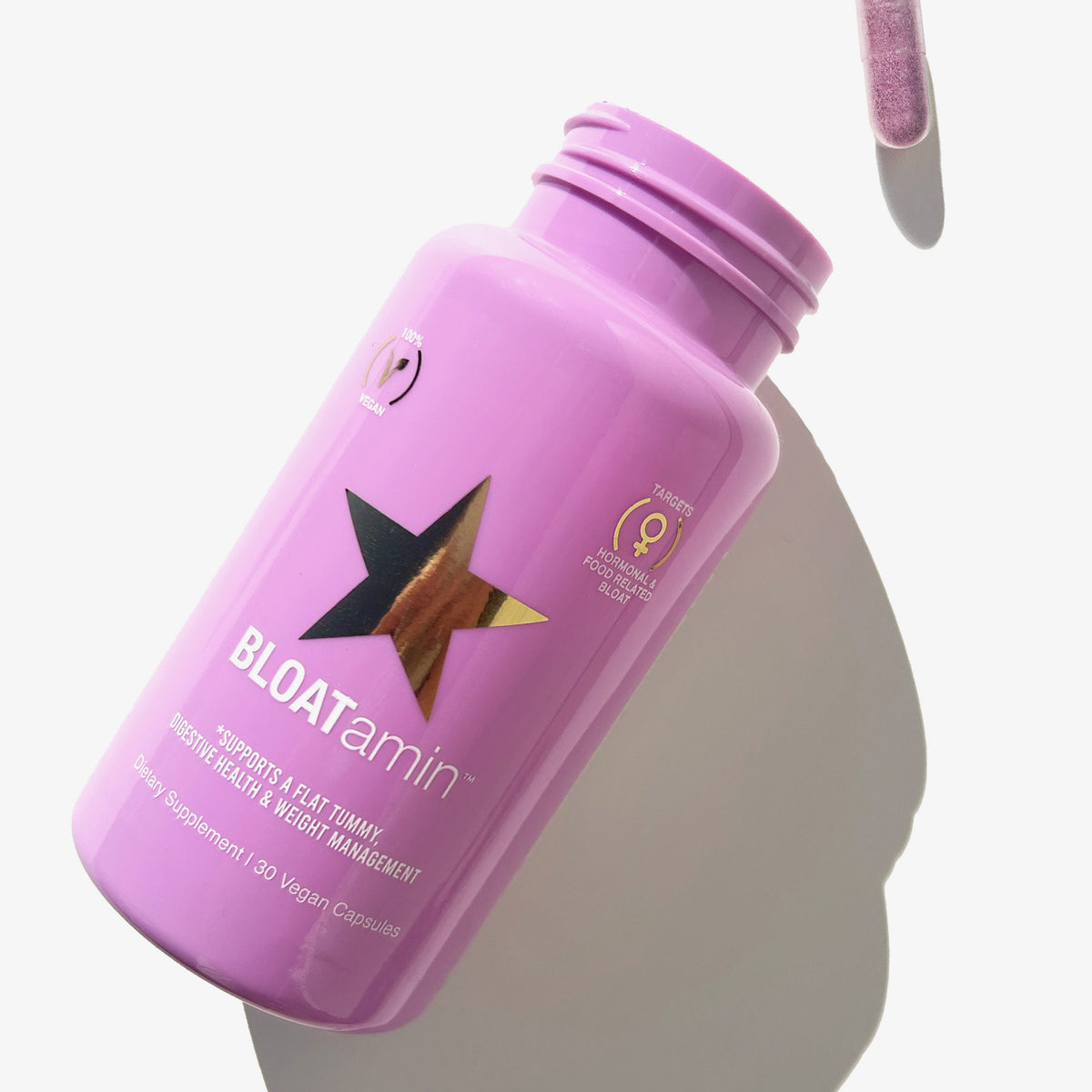 Eine Flasche BLOATamin™ 1 Month, gefüllt mit Kapseln, liegt auf einer weißen Oberfläche und wirft einen Schatten.