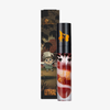 „Over The Garden Wall Potatoes & Molasses“ Lipgloss von Lethal Cosmetics in einer dunklen Verpackung im Cartoon-Stil.