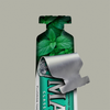 Eine ausgepackte Tube Marvis Zahnpasta Classic Strong Mint enthüllt im Inneren frische grüne Minzblätter.