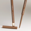 Zwei NABLA Cosmetics Cupids Arrow Micro Eyeliners in Braun, einer ohne Kappe, um die Spitze zu zeigen.