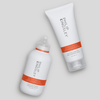 Zwei Haarpflegeprodukte von Philip Kingsley in weißer und orangefarbener Verpackung, darunter der Re-Moisturizing Conditioner.