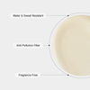 Ein cremefarbener Kreis mit Linien, die auf den Text verweisen: Wasser- und schweißresistent, Filter gegen Umweltverschmutzung und parfümfreie, talgregulierende Ultra-Fluid-Cica-Sonnencreme.