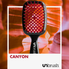 Eine schwarz-rote UNbrush Detangling Hair Brush mit einem Canyon-Hintergrund und dem Text "CANYON".