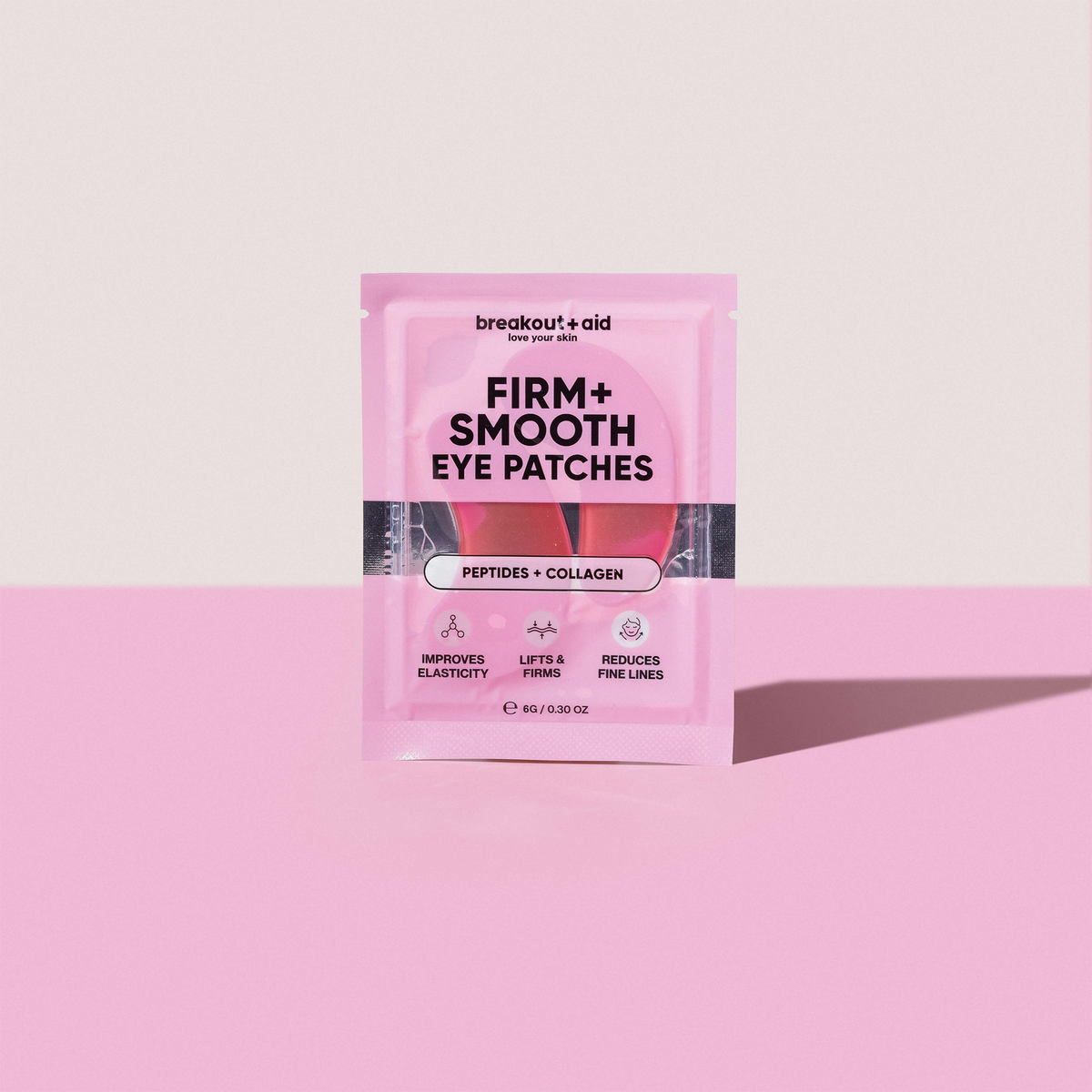 Rosa Verpackung von Firm + Smooth – Hydrogel-Augenpads von breakout+aid, mit einem Text, der die Vorteile von Kollagen und Peptiden hervorhebt.
