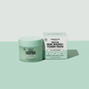Eine hellgrüne Dose und eine dazu passende quadratische Schachtel mit breakout+aid Rescue Mini Masks und Toner Pads.