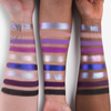 Auf drei Farbfeldern sind matte und schimmernde Farbtöne in Lila, Blau, Schwarz und neutralen Farben aus der „The Legend of Korra – Vaatu“-Palette von Lethal Cosmetics zu sehen.