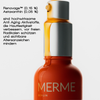 Nahaufnahme einer MERME Glowing Guard Face Oil Flasche mit deutschem Text, der die Anti-Aging Inhaltsstoffe hervorhebt.