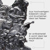 Detailaufnahme eines silberfarbenen Edelstahl-Gua-Sha mit reflektierender Oberfläche. Text: „Robust, bruchsicher & antibakteriell – ideal für Reisen und empfindliche Haut“.