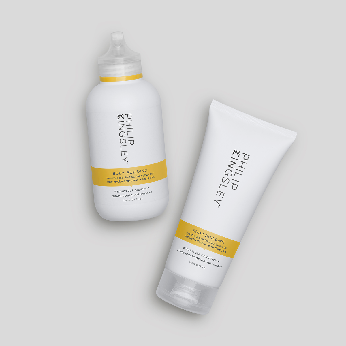 Philip Kingsley Body Building Shampoo und Conditioner vor einem hellgrauen Hintergrund.