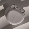 Das STYLPRO Dual Microcurrent Face & Body Toning Device mit zwei silbernen Edelstahlkugeln auf einer grauen Oberfläche mit Schattenmustern.
