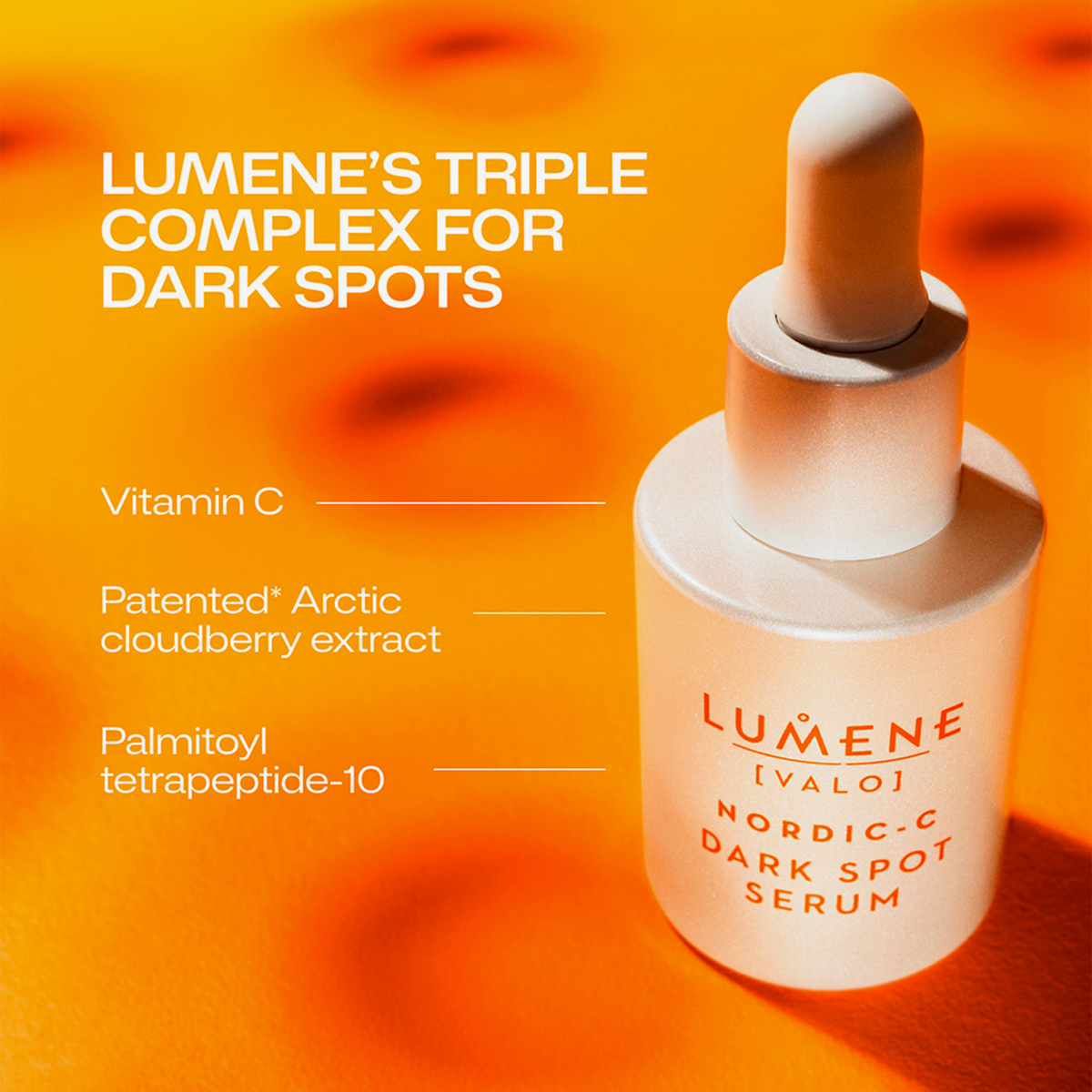 Eine Lumene Nordic-C Dark Spot Serum Tropfflasche auf orangem Hintergrund, die die wichtigsten Inhaltsstoffe hervorhebt.
