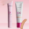 Zwei Lumene CC All-In-One Primer-Tuben auf rosa Hintergrund mit Make-up-Strichen oben und unten.