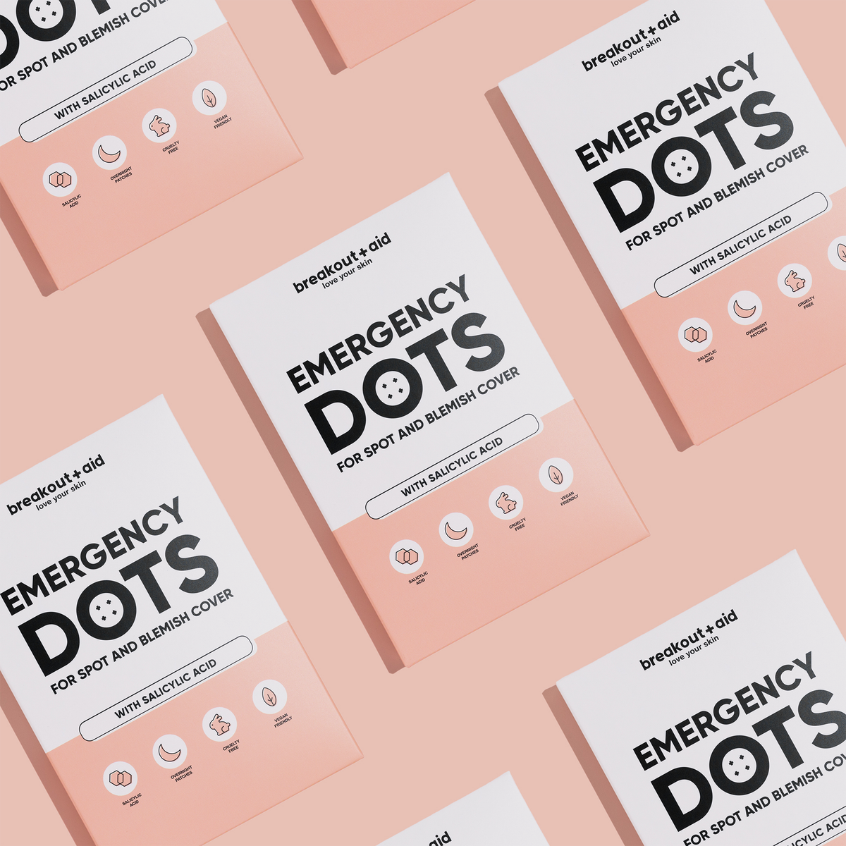 Mehrere quadratische Schachteln mit Emergency Dots – Pflaster zur Behandlung von Hautunreinheiten und Pickeln mit Salicylsäure –, die in einem Muster angeordnet sind.