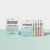 Ein Breakout+Aid Skin Mood Discovery Bundle-Set in einer Box neben fünf einzelnen Packungen mit Gesichtsmasken in verschiedenen Farben.