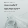 Zwei MERME Sauerstoff-Wasser 4-Wochen-Set Flaschen mit deutschem Text über Bakterien und Sauerstoff-Mikrobläschen auf hellem Hintergrund.