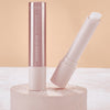 Catrice Diamond Glaze Gloss Stick in einem sWeißton, geöffnet mit sichtbarer Produktspitze, neben geschlossenem Stick auf hellem Podest.