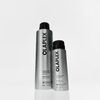Zwei silberne OLAPLEX Shape Set Haarspray-Sprühdosen unterschiedlicher Größe mit schwarzen Sprühköpfen.