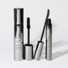Zwei Metalltuben mit „XLASH Drama Tinted Primer“, eine verschlossen und eine geöffnet, mit einem schwarzen Applikator, vor weißem Hintergrund.