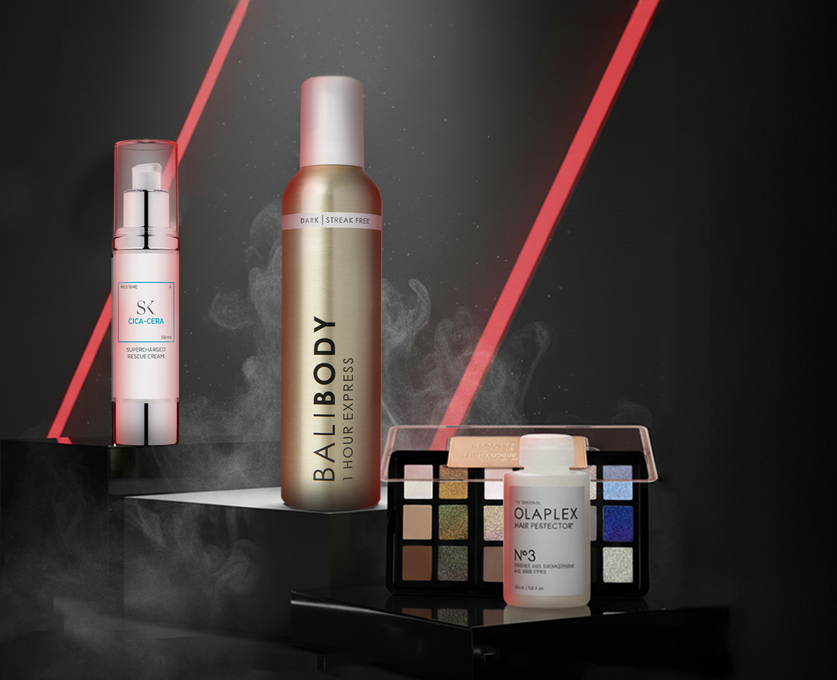 Vier Beauty-Produkte vor dunklem Hintergrund mit roten Lichtstreifen: Skintegra Cica-Cera, Bali Body 1 Hour Express, Danessa Myricks Palette und OLAPLEX No.3.