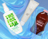 Drei Beauty‑Produkte vor blauem, geschwungenem Hintergrund: The Fox Tan Rapid Mist, eine koreanische Sonnencreme und Bali Body SPF50 Watermelon Tanning Oil.