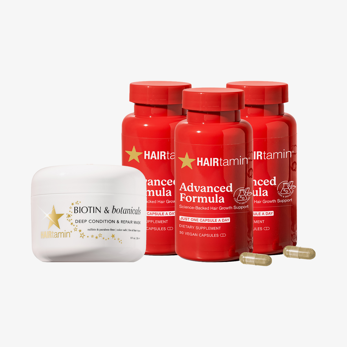 HAIRtamin Advanced Haircare Bundle mit drei Advanced Formula Kapsel-Flaschen, Biotin & Botanicals Haarmaske und Kapseln im Vordergrund.
