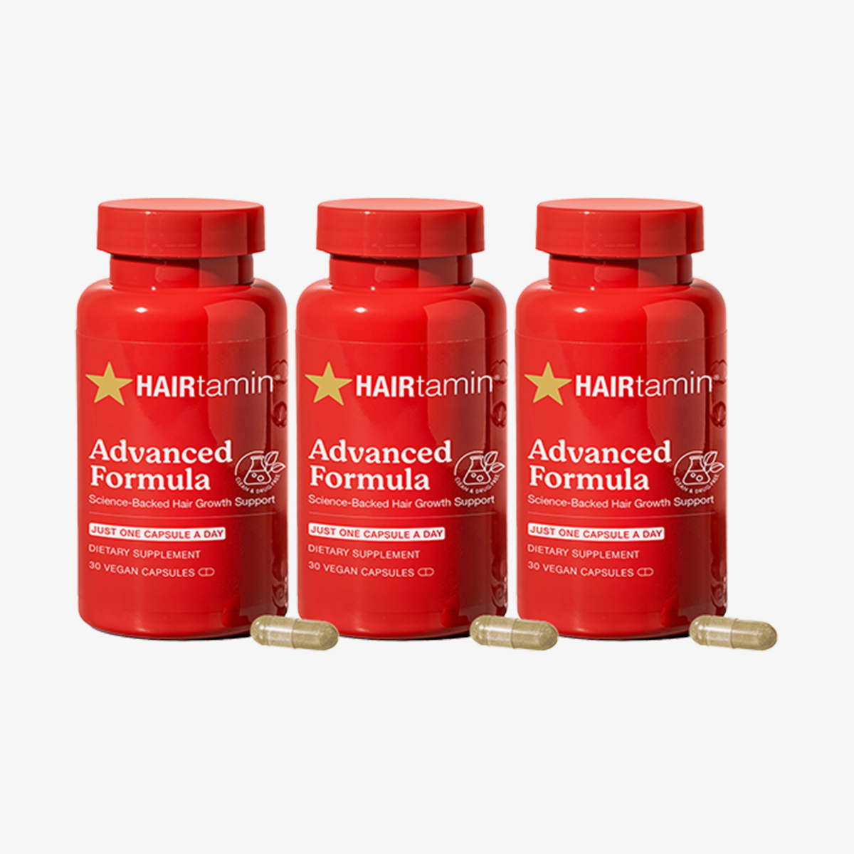 HAIRtamin Advanced Formula 3-Monats-Bundle mit drei roten Flaschen Nahrungsergänzung und sichtbaren Kapseln für Haarwachstum.